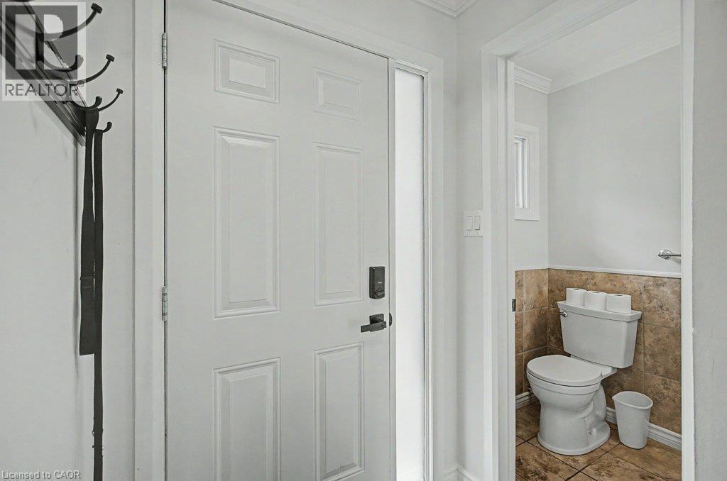 Panel door with frosted glass side-light and smart lock - 2050 Upper Middle Road Unit# 164, Burlington, ON - Indoor Photo Showing Bathroom