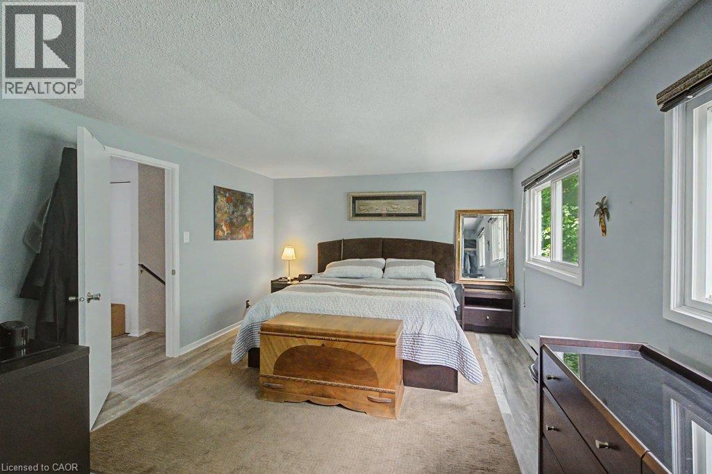 Expansive room featuring two windows, light blue walls, and a recessed doorway - 2050 Upper Middle Road Unit# 164, Burlington, ON - Indoor Photo Showing Bedroom