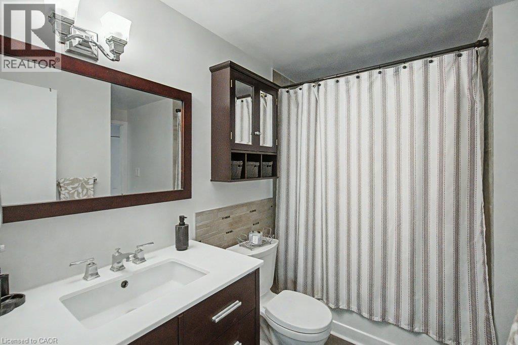 Vanity with an integrated rectangular sink and polished chrome faucet - 2050 Upper Middle Road Unit# 164, Burlington, ON - Indoor Photo Showing Bathroom