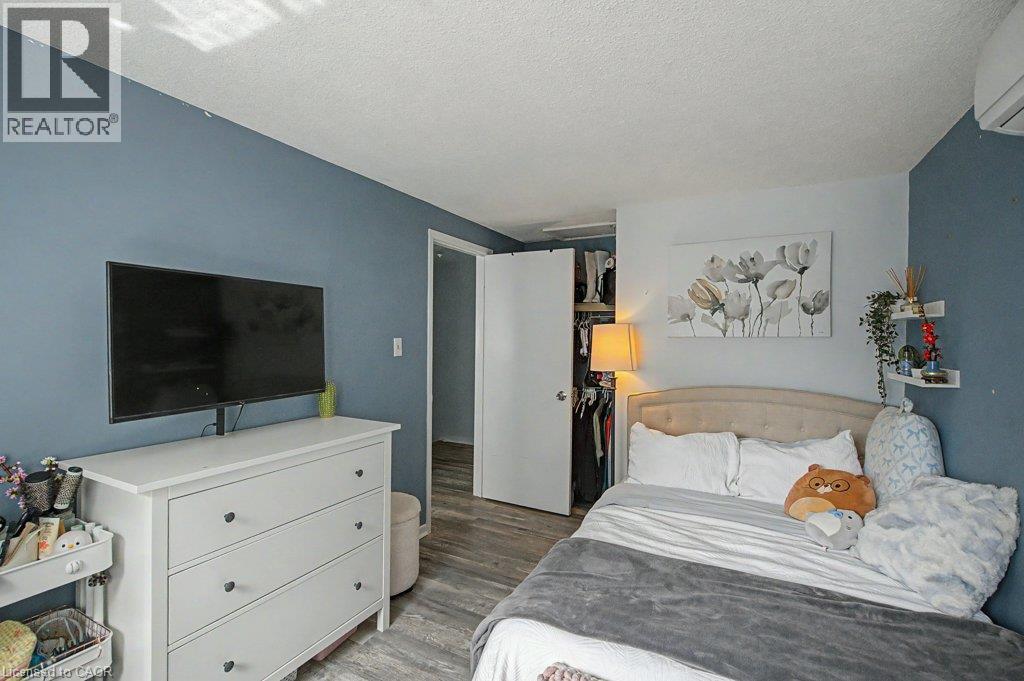 Wood-finish flooring throughout - 2050 Upper Middle Road Unit# 164, Burlington, ON - Indoor Photo Showing Bedroom