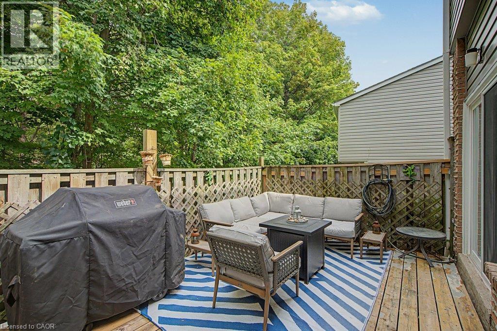 Private wood deck with lattice fencing and mature perimeter trees - 2050 Upper Middle Road Unit# 164, Burlington, ON - Outdoor With Deck Patio Veranda With Exterior