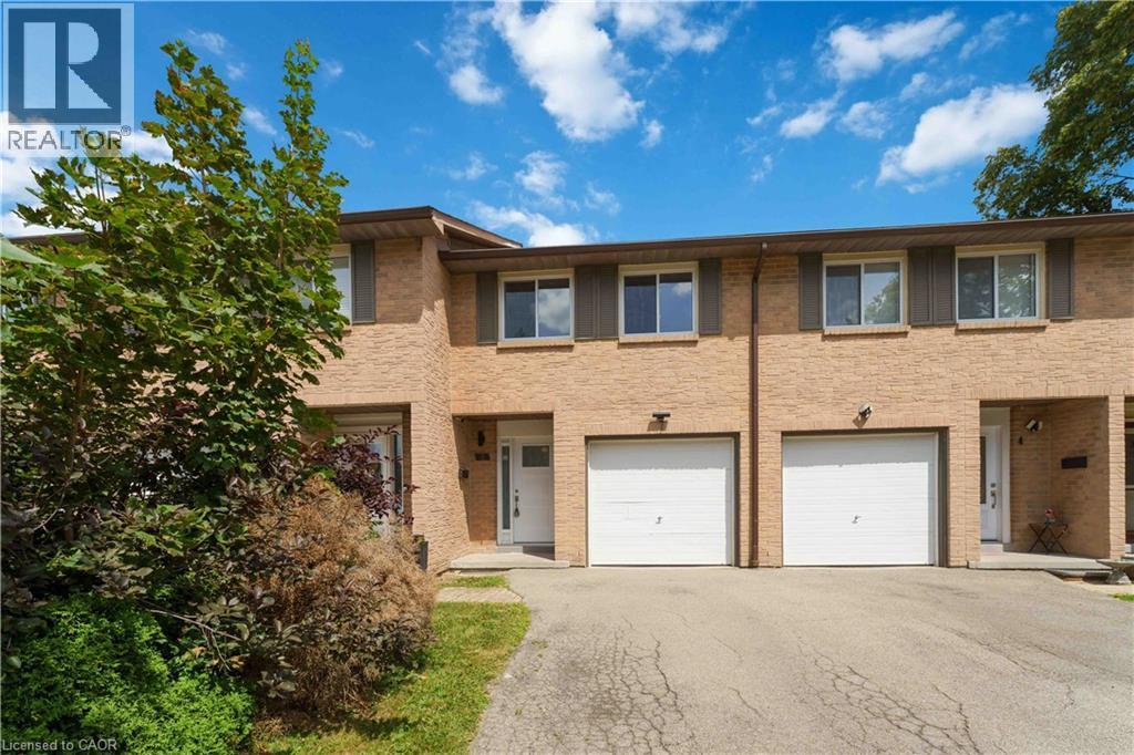 Brick exterior with multiple windows, individual front entrances, and two attached garages - 66 Summercrest Drive Unit# 3, Hamilton, ON - Outdoor