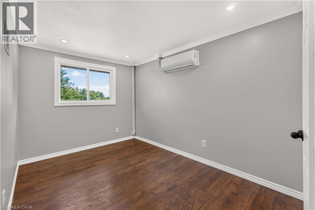 Recessed lighting, crown molding, wood-finish flooring, and a window with white trim - 66 Summercrest Drive Unit# 3, Hamilton, ON - Indoor Photo Showing Other Room