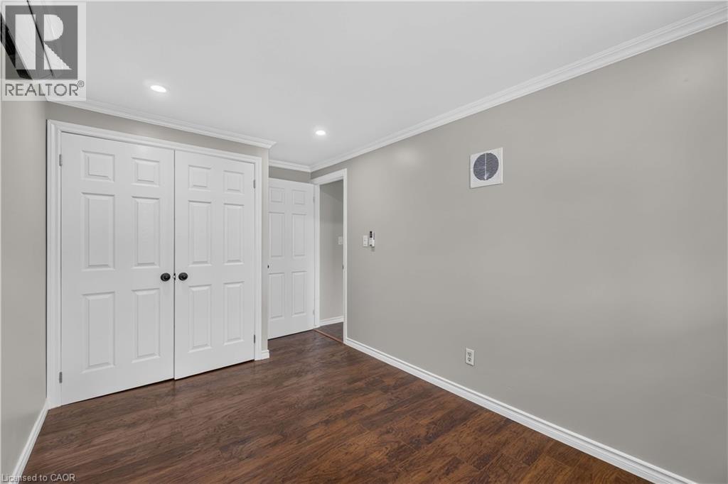 Wood-finish flooring with white baseboards, recessed lighting, and a ductless mini-split system - 66 Summercrest Drive Unit# 3, Hamilton, ON - Indoor Photo Showing Other Room