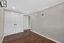 Wood-finish flooring with white baseboards, recessed lighting, and a ductless mini-split system -
