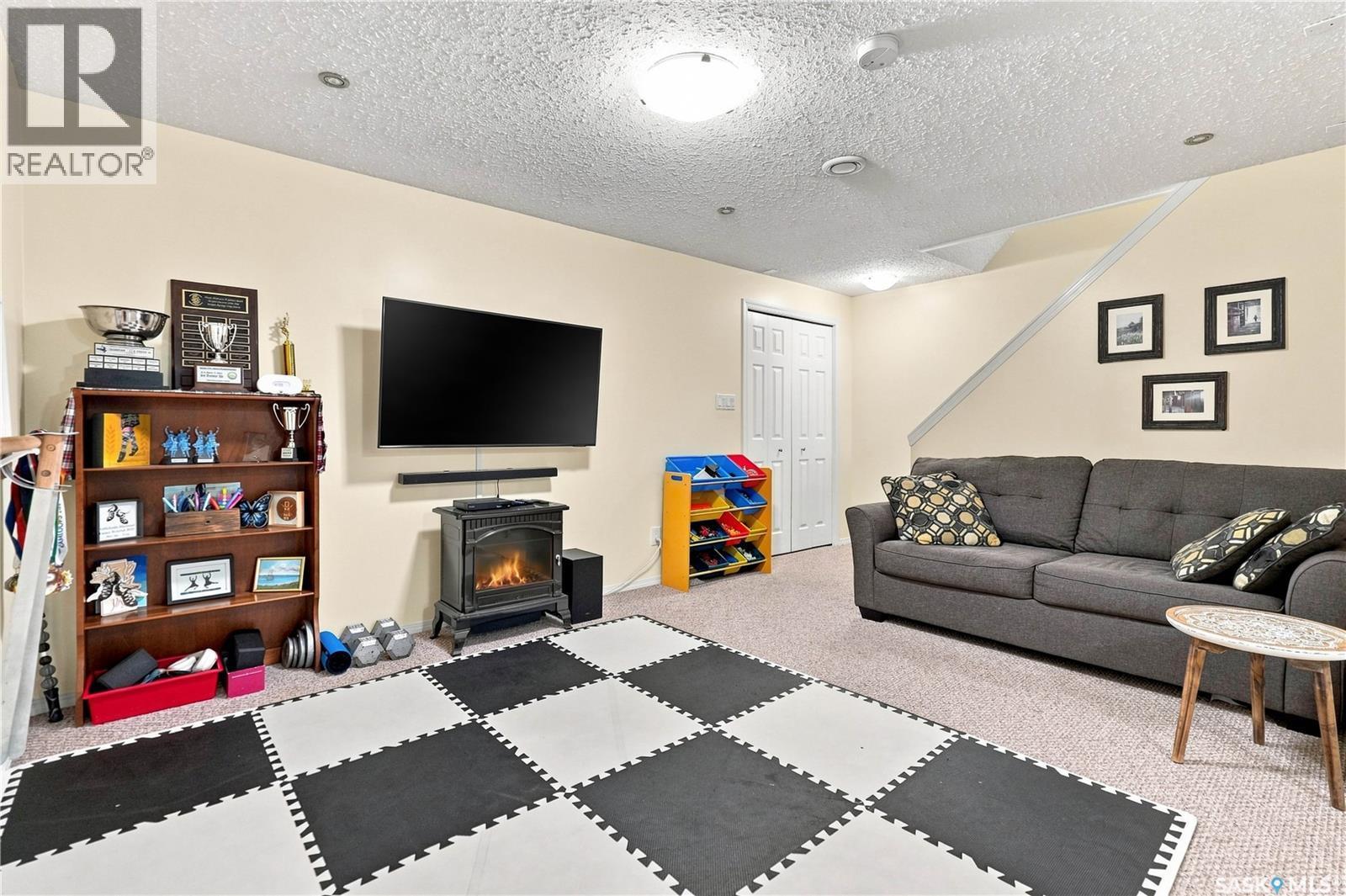 1030 Orchid Way N, Regina, SK - Indoor Photo Showing Living Room With Fireplace
