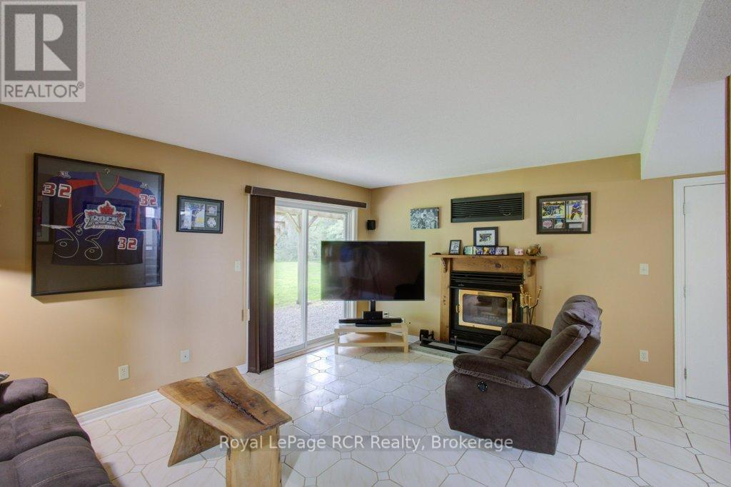 7287 Wellington Rd 109, Mapleton, ON - Indoor Photo Showing Living Room With Fireplace