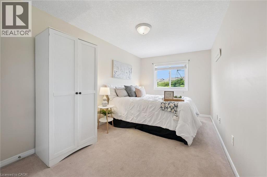 Recessed window, white painted walls, ceiling-mounted light fixture, light-colored carpet flooring - 308 Parkvale Drive, Kitchener, ON - Indoor Photo Showing Bedroom
