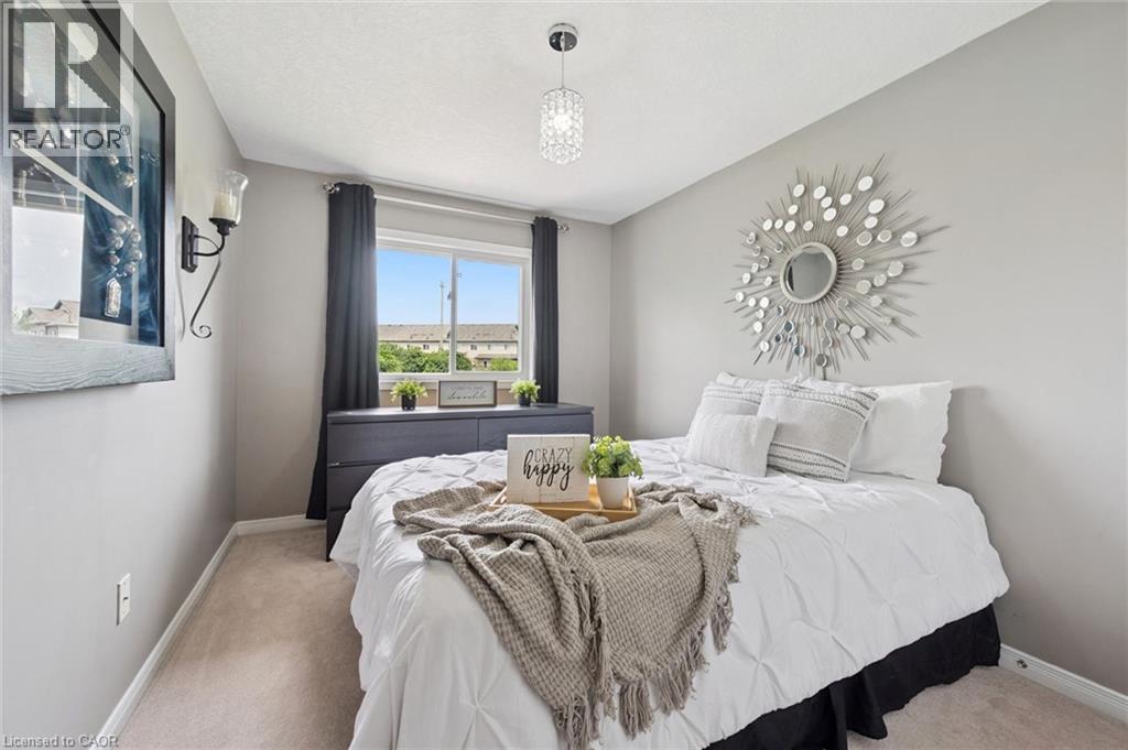 Recessed lighting, wall-mounted sconce, and a rectangular window with dark drapery - 308 Parkvale Drive, Kitchener, ON - Indoor Photo Showing Bedroom