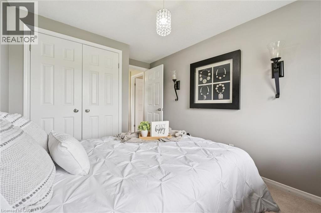 Double-door closet with paneling and chrome hardware - 308 Parkvale Drive, Kitchener, ON - Indoor Photo Showing Bedroom