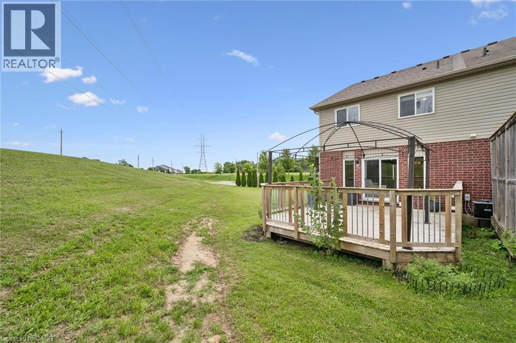 Expansive wooden deck with a metal gazebo frame, featuring a sliding glass door entry to the interior - 308 Parkvale Drive, Kitchener, ON - Outdoor