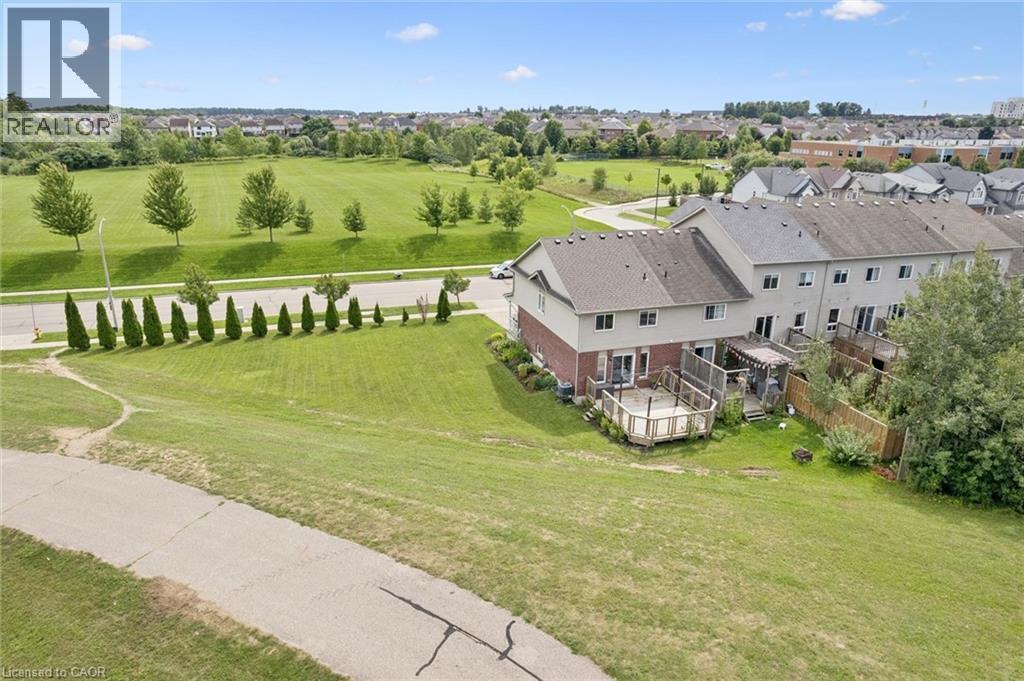 Tiered wooden deck, expansive lawn, mature trees, paved pathway, residential community - 308 Parkvale Drive, Kitchener, ON - Outdoor With View