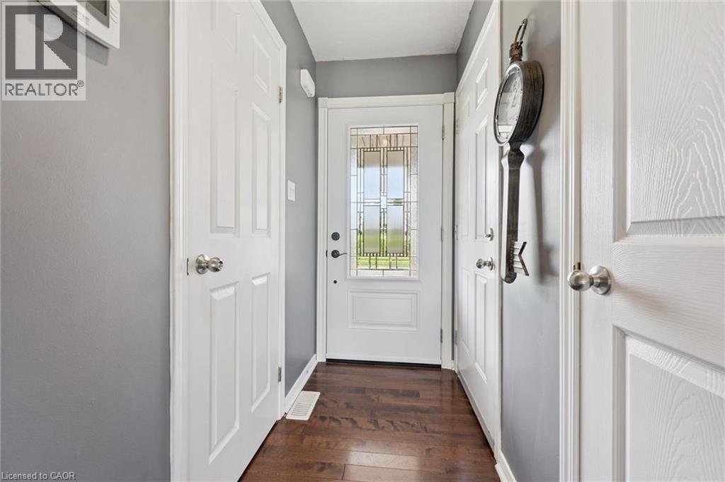 Entryway featuring a decorative glass panel door, dark wood-finish flooring, and crisp white trim - 308 Parkvale Drive, Kitchener, ON - Indoor Photo Showing Other Room