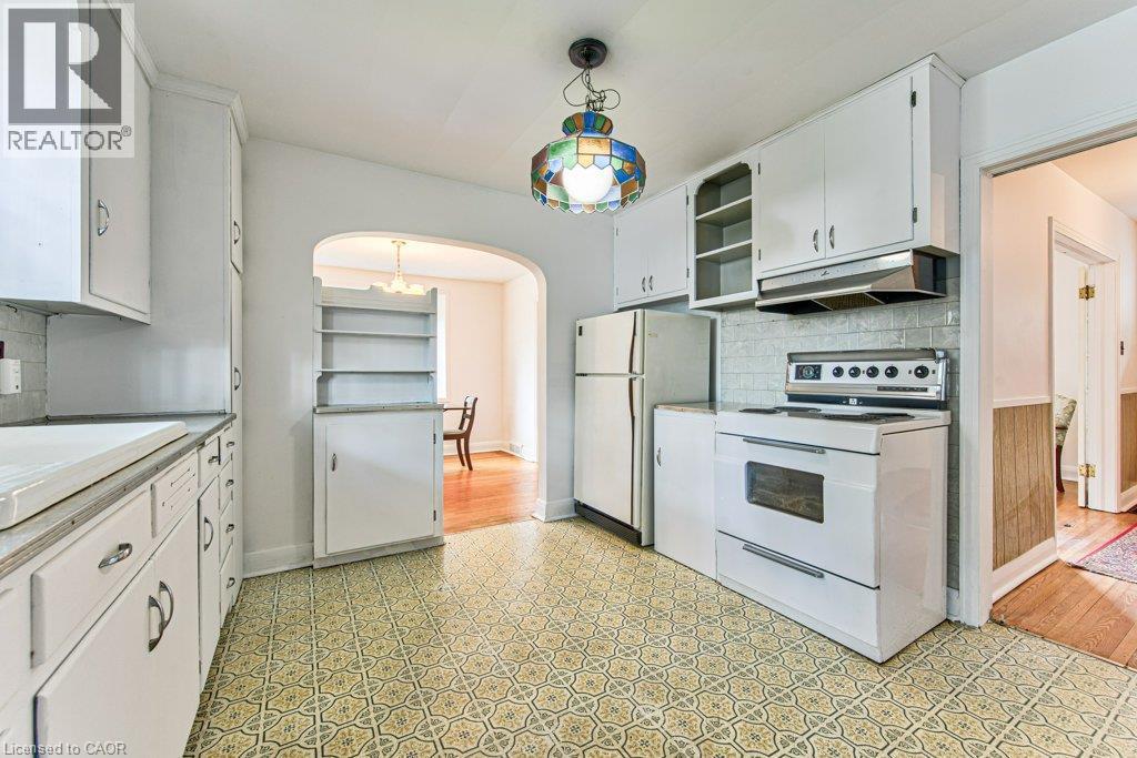 White cabinetry with open shelving and tile backsplash - 321 Highland Park, Cambridge, ON