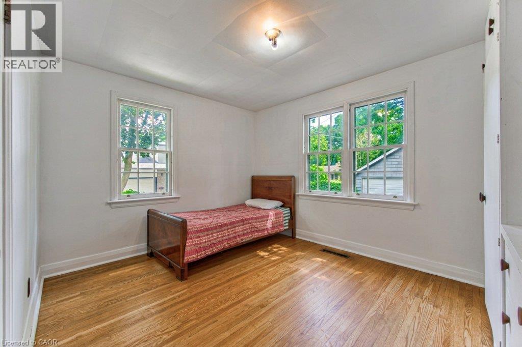 Hardwood flooring, white walls, two double-hung windows, and a built-in wall cabinet - 321 Highland Park, Cambridge, ON