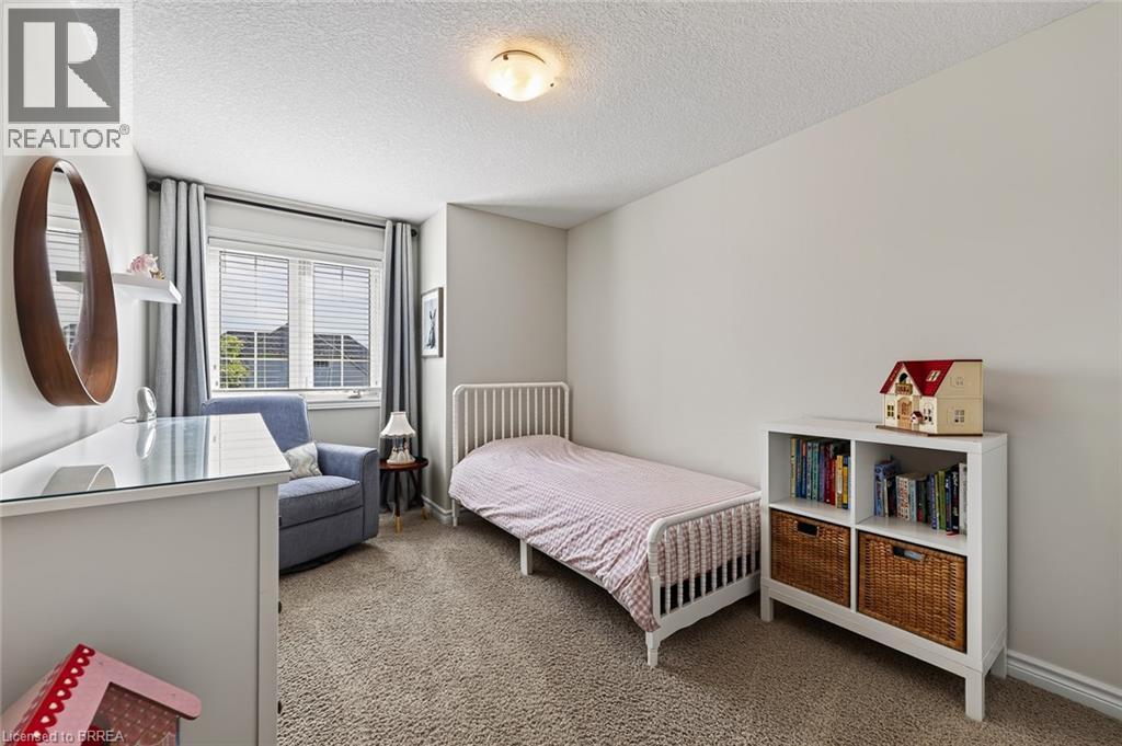 Neutral wall tones, wall-to-wall carpeting, and a window with blinds and drapery - 783 Frontenac Crescent, Woodstock, ON - Indoor Photo Showing Bedroom