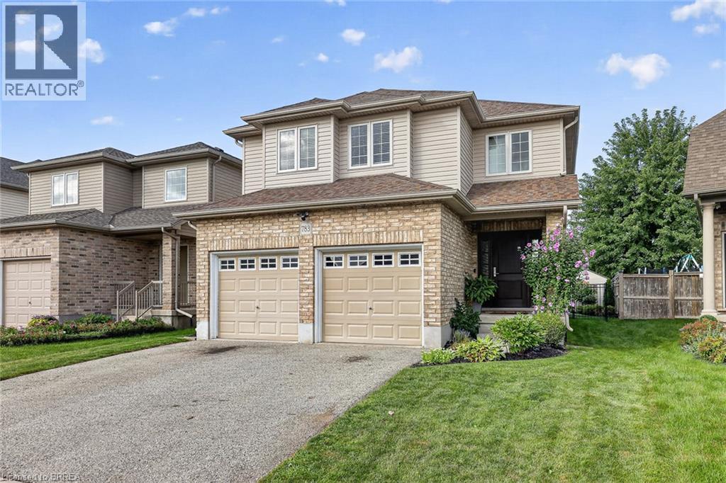Two-story residence featuring a brick and siding exterior, an attached two-car garage, and a paved driveway - 783 Frontenac Crescent, Woodstock, ON - Outdoor