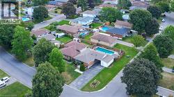 Residential property with a swimming pool, mature landscaping, and a paved driveway - 