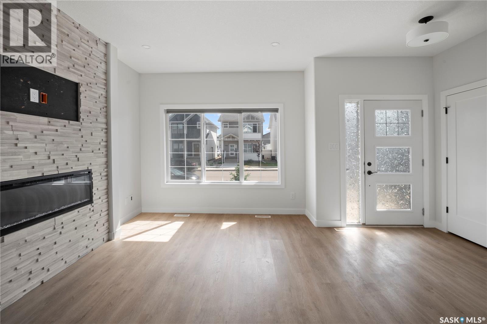 5116 E Simard Avenue, Regina, SK - Indoor Photo Showing Other Room With Fireplace
