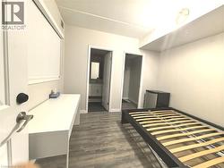 Wood-finish flooring, built-in desk, and ceiling-mounted lighting - 