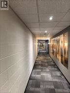 Textured wall finish, recessed lighting, drop ceiling, and patterned carpet flooring - 