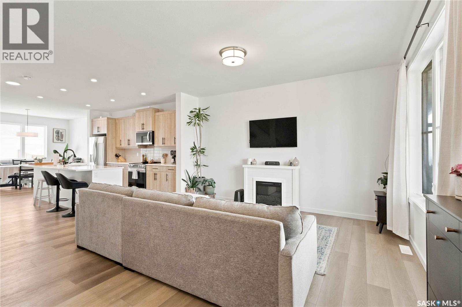 3089 Brighton Common, Saskatoon, SK - Indoor Photo Showing Living Room With Fireplace
