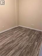 Wood-finish flooring with light-toned walls and white trim - 