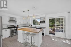 Kitchen with sliding glass door to backyard deck - 