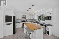 Kitchen with gas stove & stainless appliances - 