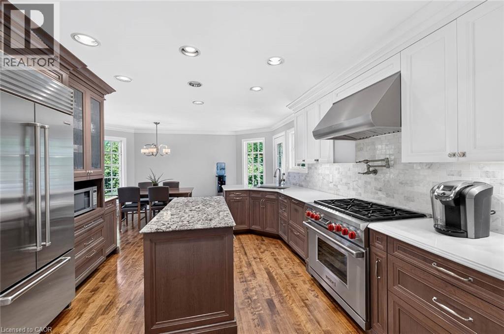 Gourmet kitchen featuring a center island, stainless steel appliances, wood-finish flooring, white countertops, and recessed lighting - 11 Christman Court, Markham, ON - Indoor Photo Showing Kitchen With Upgraded Kitchen