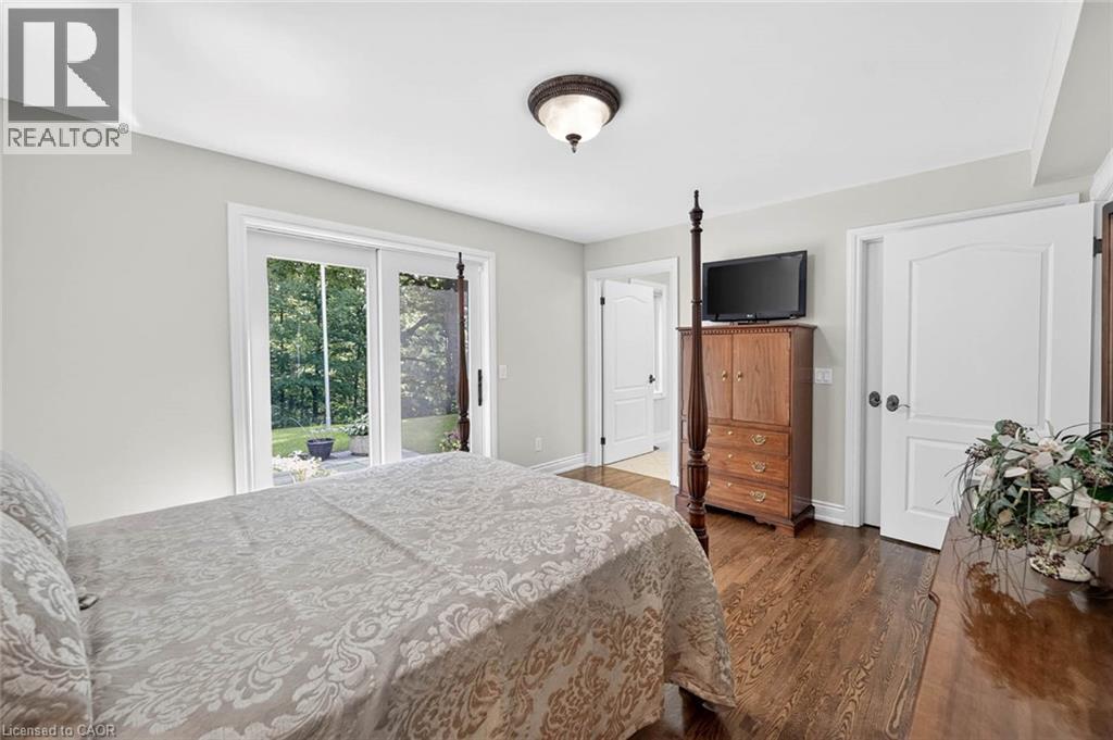 Hardwood flooring, white interior doors, sliding glass patio doors, and a flush mount ceiling light fixture - 11 Christman Court, Markham, ON - Indoor Photo Showing Bedroom