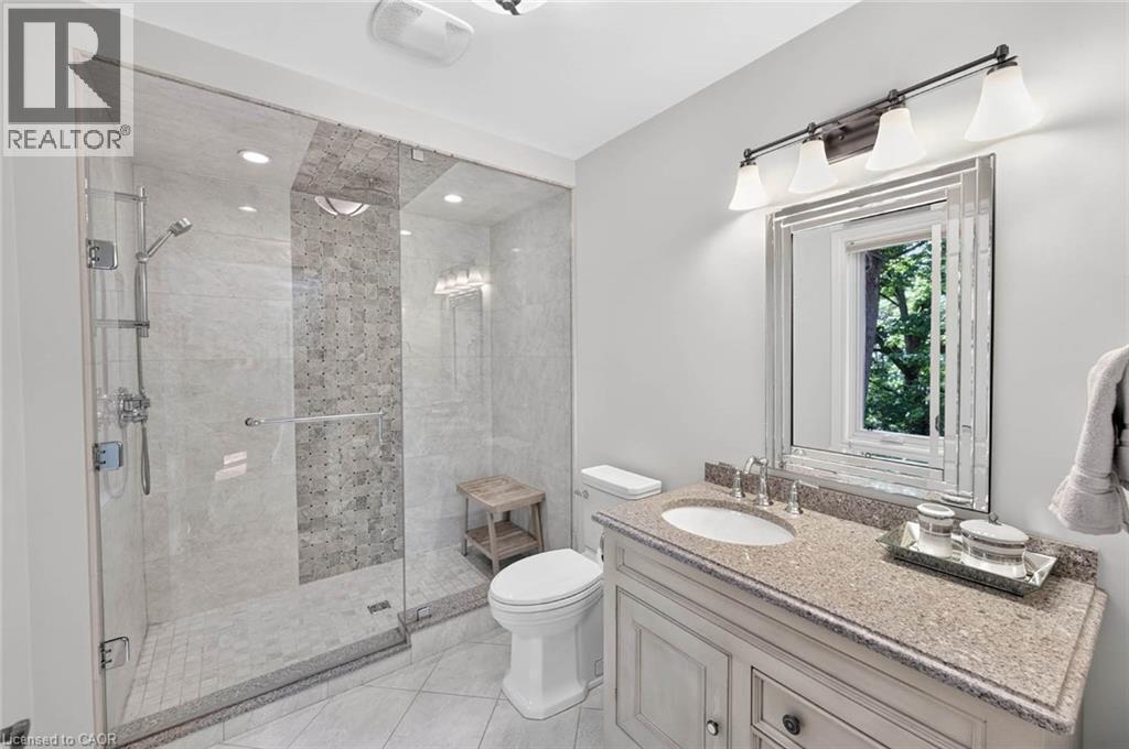 Glass-enclosed shower with tile surround and mosaic accent - 11 Christman Court, Markham, ON - Indoor Photo Showing Bathroom