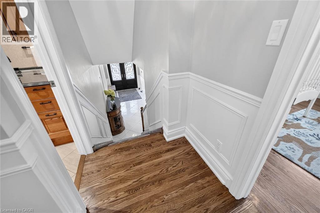 Hardwood flooring, wainscoting, light gray wall paint, and white trim - 11 Christman Court, Markham, ON - Indoor Photo Showing Other Room
