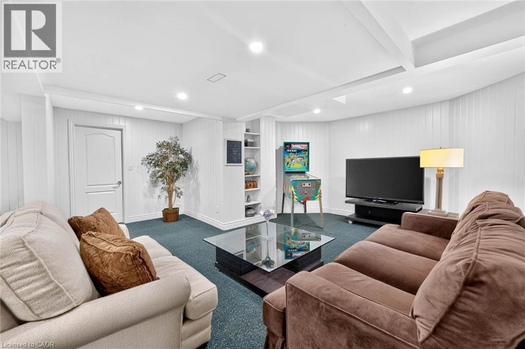 Recessed ceiling lighting, white paneling, integrated shelving unit, single panel interior door, and blue carpet flooring - 11 Christman Court, Markham, ON - Indoor Photo Showing Living Room