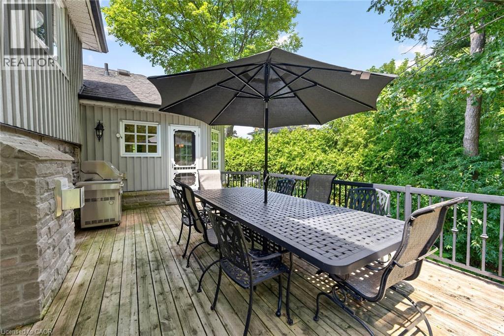 Expansive wood deck with a stone-clad outdoor cooking area and a metal railing system - 11 Christman Court, Markham, ON - Outdoor With Deck Patio Veranda With Exterior