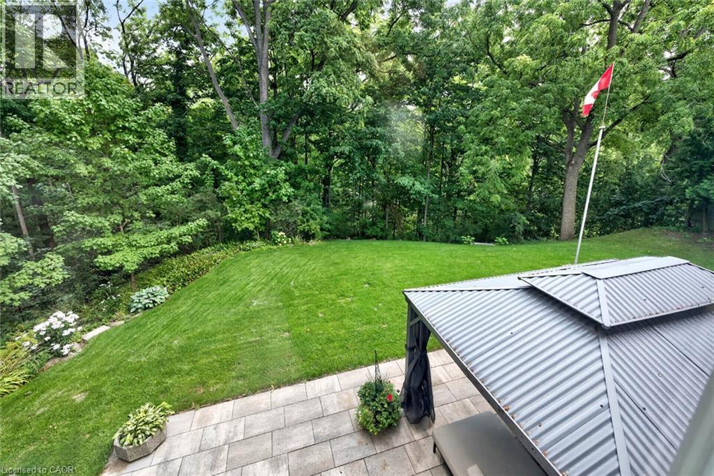 Expansive backyard featuring a manicured lawn, established perimeter trees, and a paver patio with an attached gazebo - 11 Christman Court, Markham, ON - Outdoor With Deck Patio Veranda