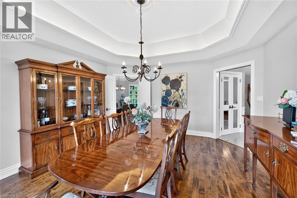 Wood-finish flooring with a tray ceiling and a chandelier - 11 Christman Court, Markham, ON - Indoor Photo Showing Dining Room