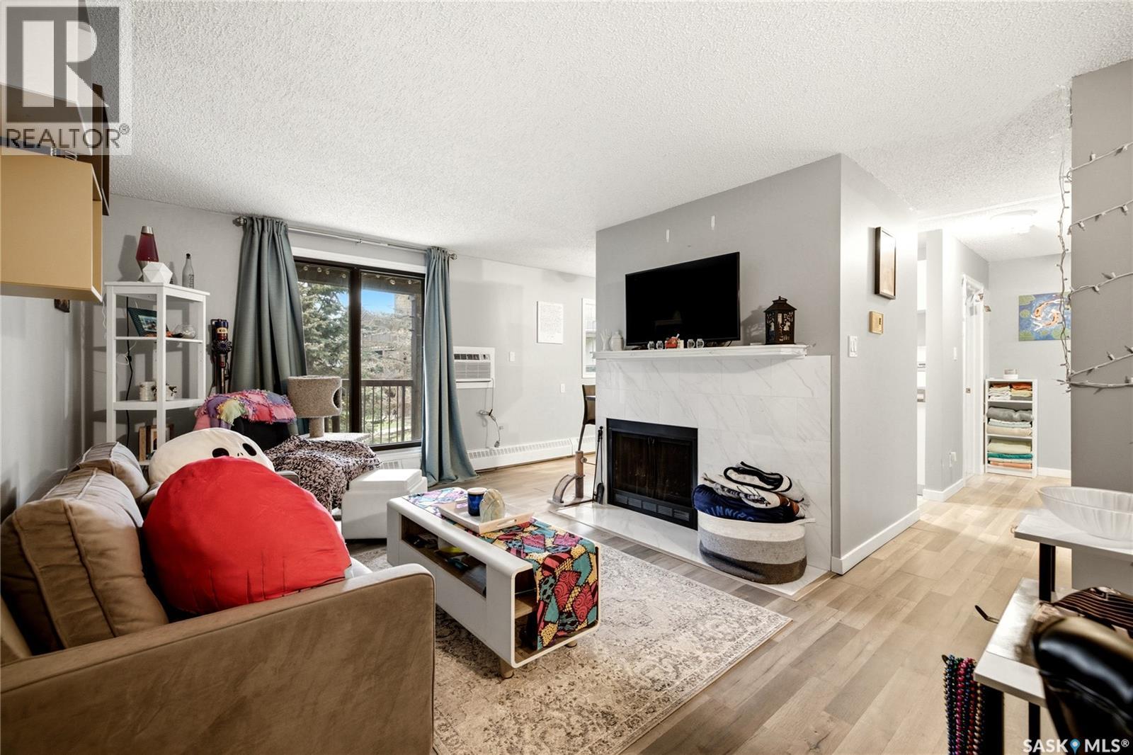 205 31 Rodenbush Drive, Regina, SK - Indoor Photo Showing Living Room With Fireplace