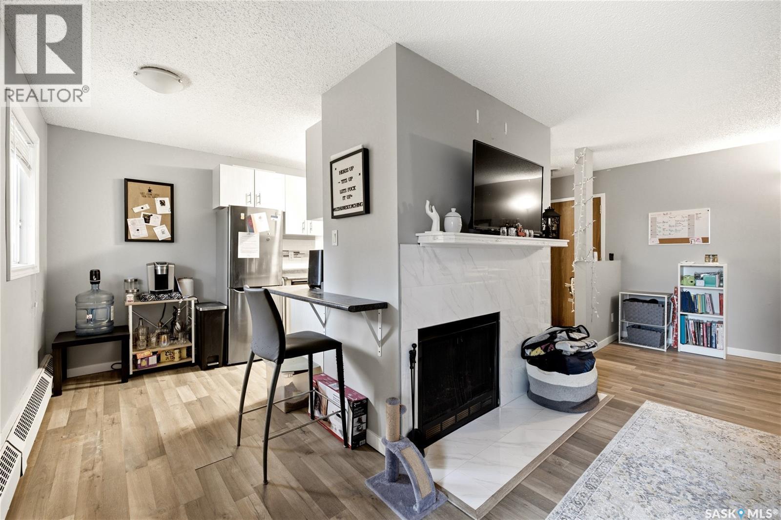 205 31 Rodenbush Drive, Regina, SK - Indoor Photo Showing Other Room With Fireplace