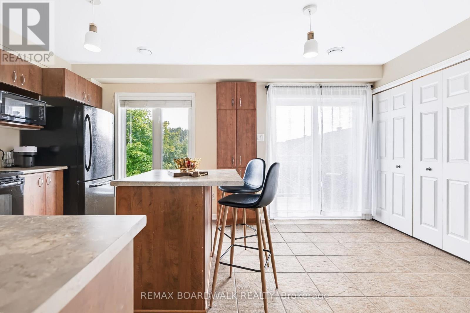 Kitchen features Tile Floors & a Large Island - 312 Galston Private, Ottawa, ON