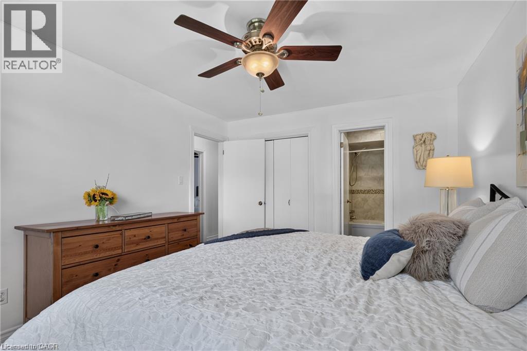 Bright primary bedroom featuring soft natural light, ceiling fan and access to semi-ensuite - 1083 Melton Drive, Mississauga, ON