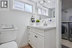 White vanity with cabinet storage and drawers, white countertop, and a chrome faucet - 