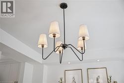 Black metal chandelier with five fabric shades and recessed ceiling lights - 