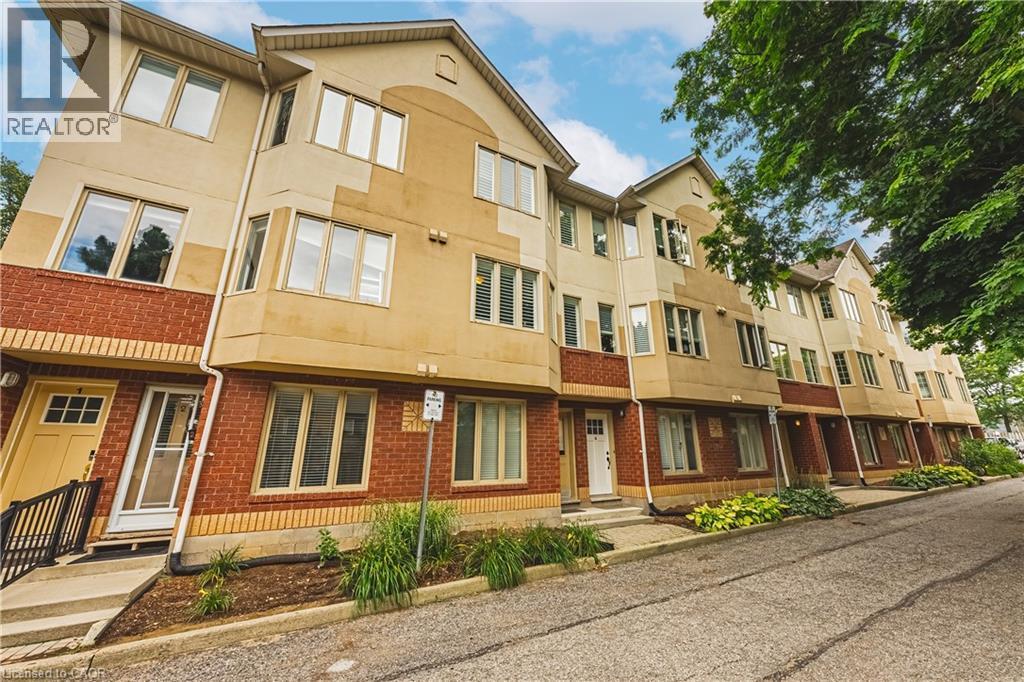 Brick and stucco facade with multiple windows, individual entryways, and varied architectural rooflines - 266 Limeridge Road E Unit# 3, Hamilton, ON