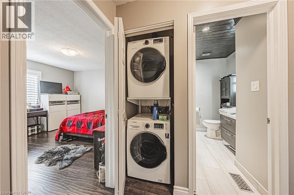 Stacked laundry appliances within a dedicated closet - 266 Limeridge Road E Unit# 3, Hamilton, ON