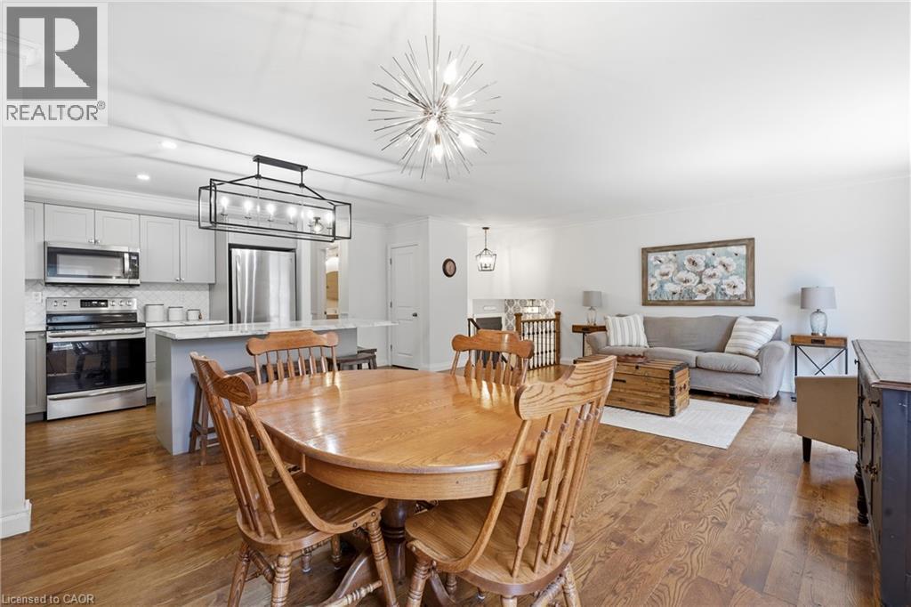 Open-concept living area featuring wood-finish flooring throughout - 72 Crestlynn Crescent, Simcoe, ON