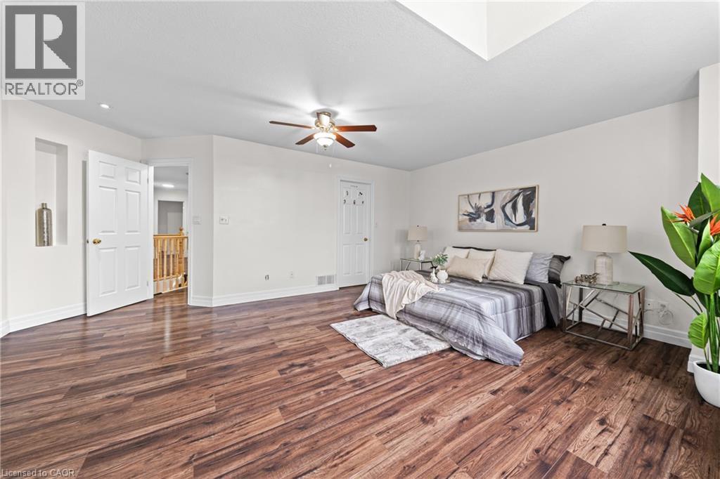 Wood-finish flooring, white walls, ceiling fan, recessed lighting, and a built-in wall niche - 495 Brigantine Drive, Waterloo, ON