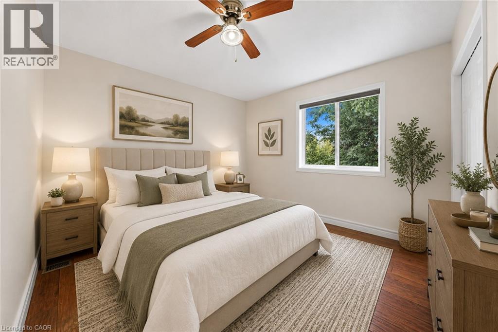 Hardwood flooring, recessed lighting, ceiling fan, large window, and upholstered headboard - 495 Brigantine Drive, Waterloo, ON
