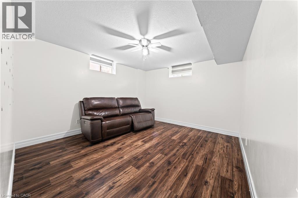 Wood-finish flooring, white walls, and a ceiling fan with light fixture - 495 Brigantine Drive, Waterloo, ON