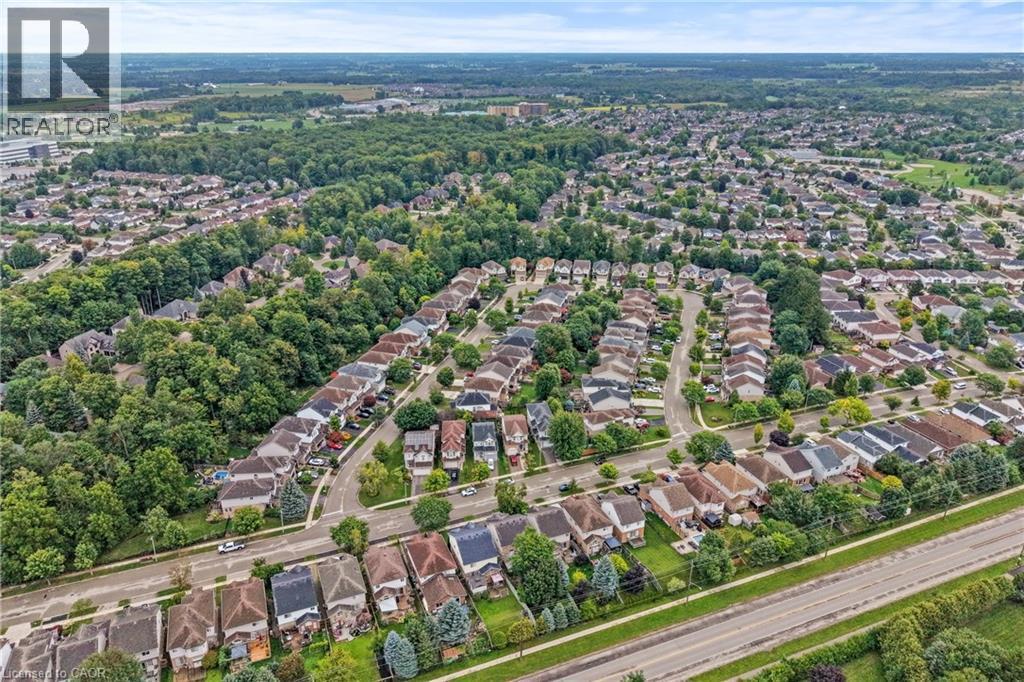 Aerial perspective of a developed residential area featuring numerous detached homes with varied architectural styles and surrounding green spaces - 495 Brigantine Drive, Waterloo, ON